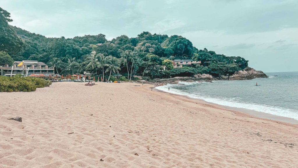 Serene beach at Koh Samui with lush greenery and calm waters.