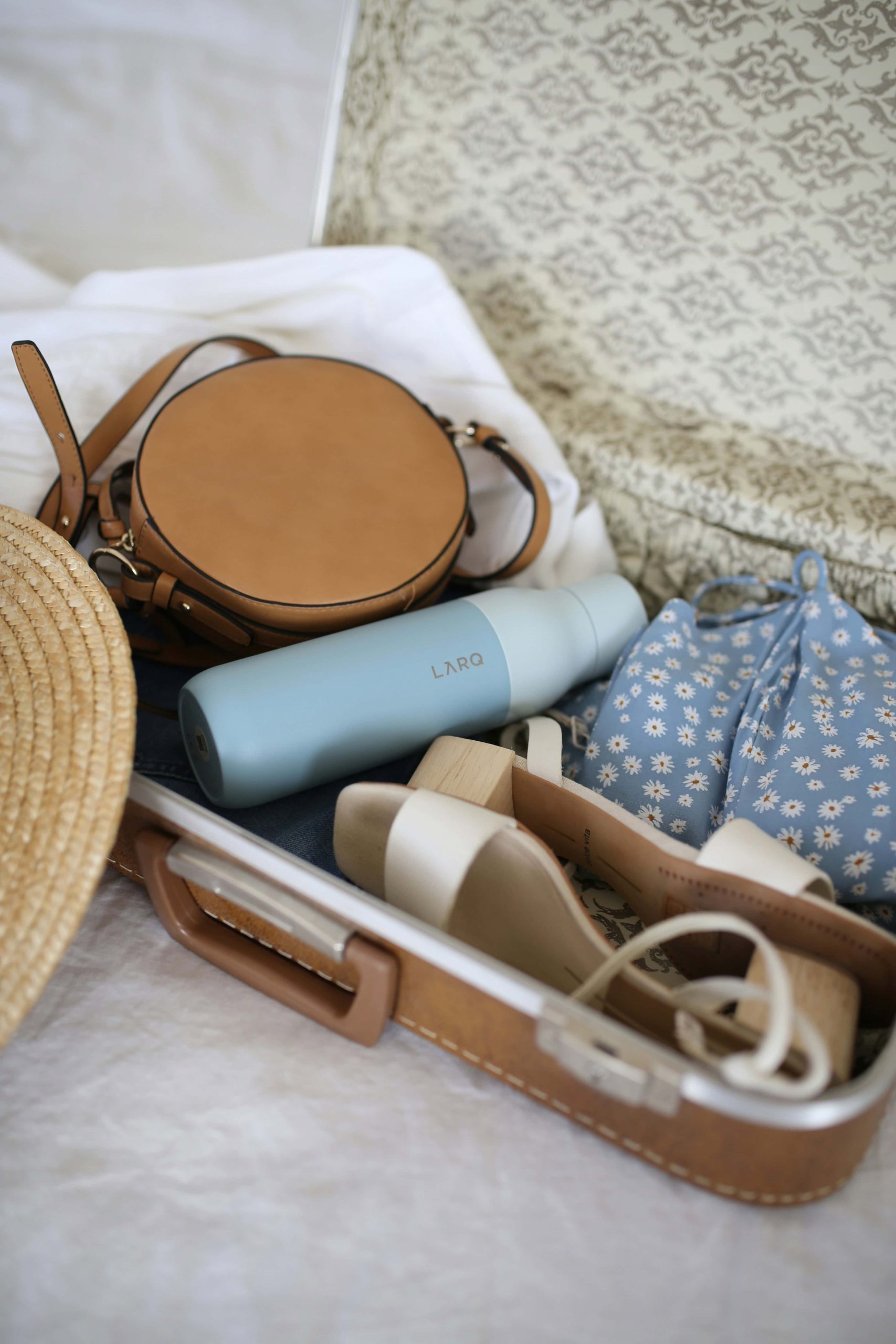Luxury travel essentials packed in a carry-on for two weeks.