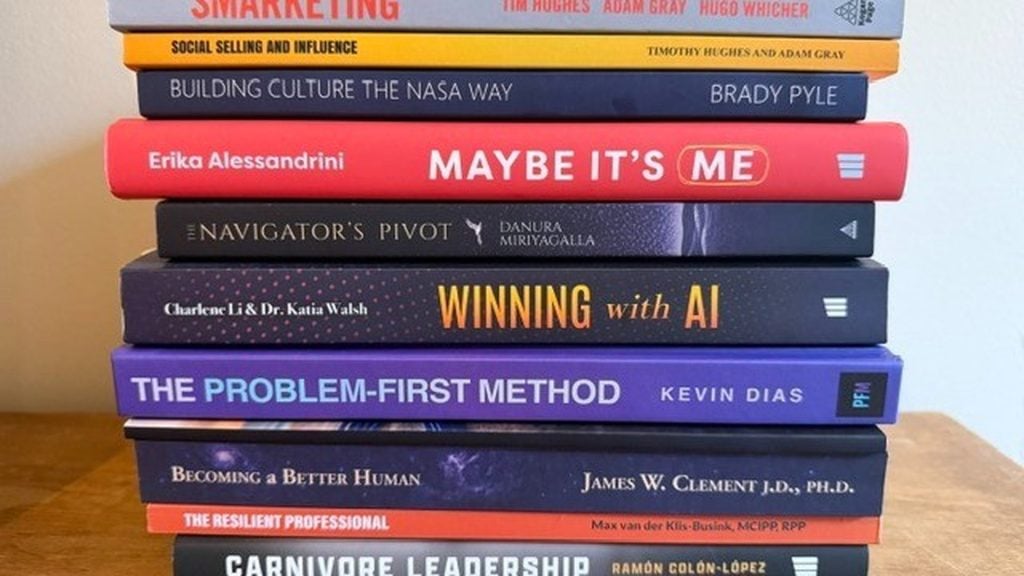 Tim Hughes' Executive Bookshelf featuring ten leadership books including Finding Direction in the Age of AI by Michael Earls