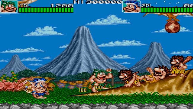 Classic arcade game with cavemen and dinosaurs in a prehistoric landscape.