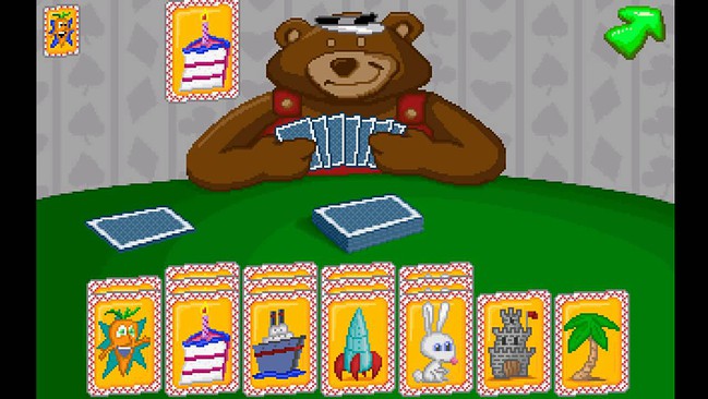 Colorful digital image of a classic card game featuring a teddy bear with playing cards, vibrant card designs, and playful theme.