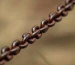 Detailed macro shot of a rusty metal chain outdoors in Minas Gerais, Brazil.