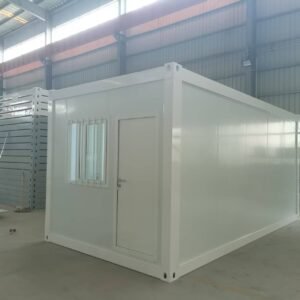 High-quality white modular prefabricated container unit inside a spacious industrial warehouse, showcasing customizable modular building solutions and efficient construction ready for assembly or deployment.