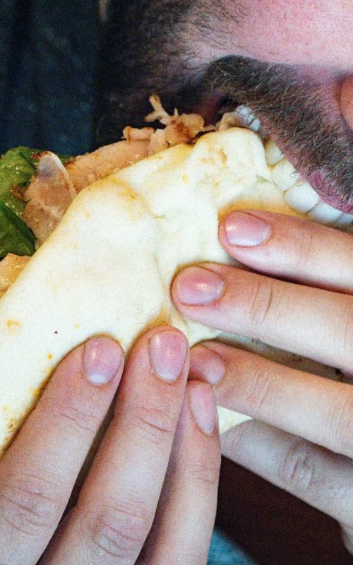 Tasty taco with meat, lettuce, and cheese, perfect for a quick meal or snack.