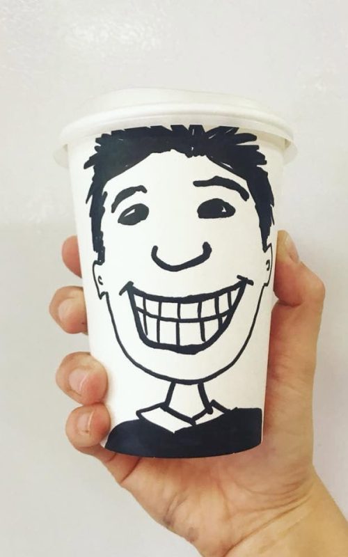 Happy coffee cup with a smiling face illustration.