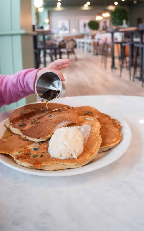 Freshly made pancakes with syrup and ice cream at Mudpenny restaurant.