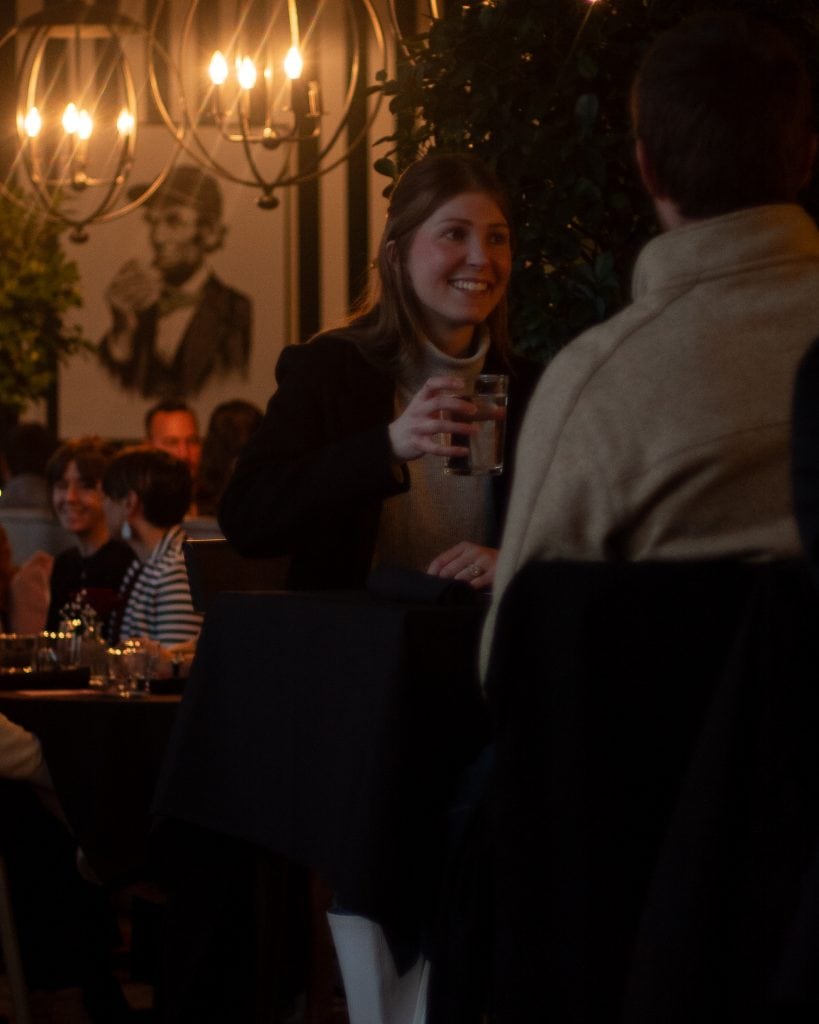 Happy woman enjoying drinks at Spring Lake event.