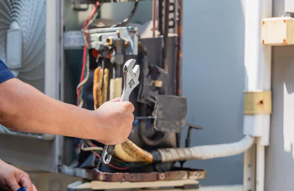 HIGH-QUALITY HVAC AND PLUMBING REPAIR SERVICES BY TOP-RATED MY JOCKEY TECHNICIAN WORKING ON AN AIR CONDITIONING UNIT. EXPERT COOLING, HEATING, AND PLUMBING SOLUTIONS FOR HOMES AND BUSINESSES.