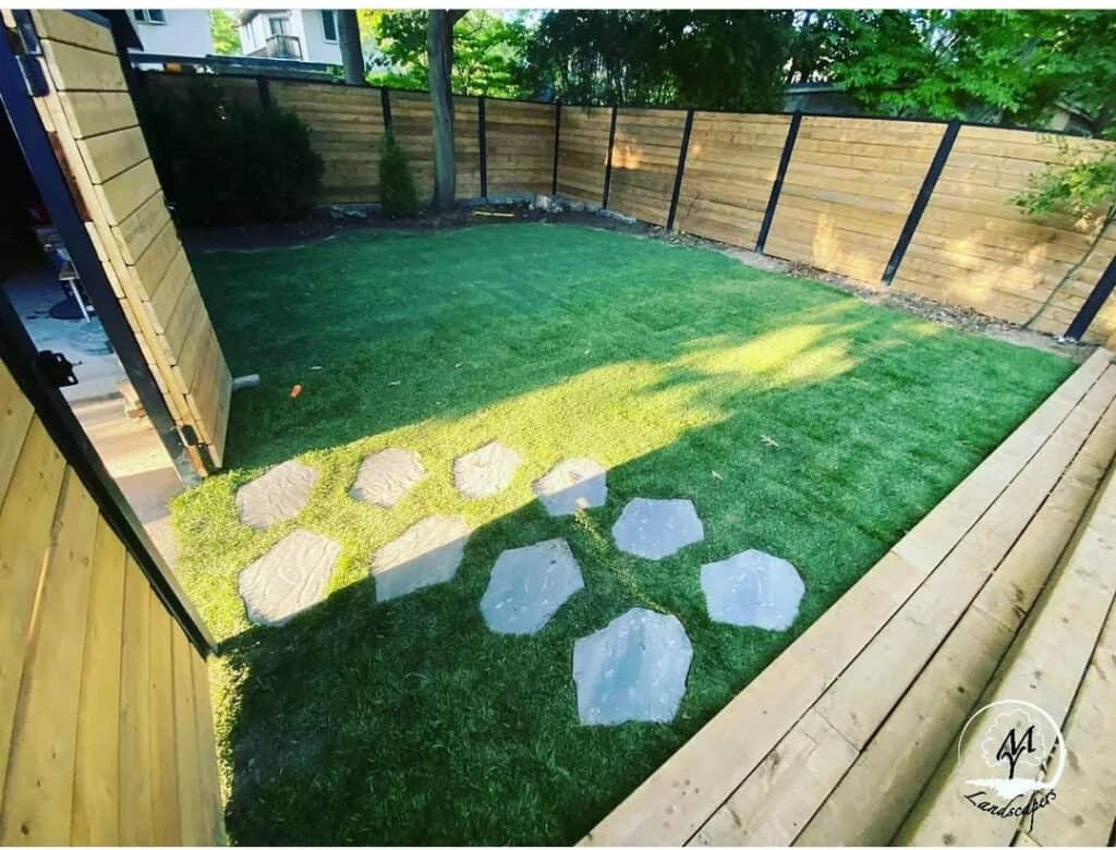 Local lawn care professional practicing eco-friendly mowing techniques in a garden