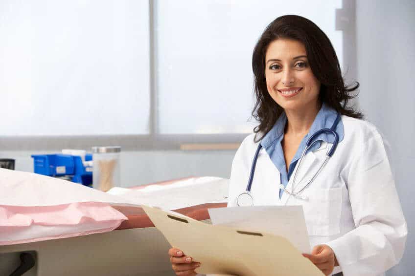 Fertility specialist at Nandi IVF holding patient records.