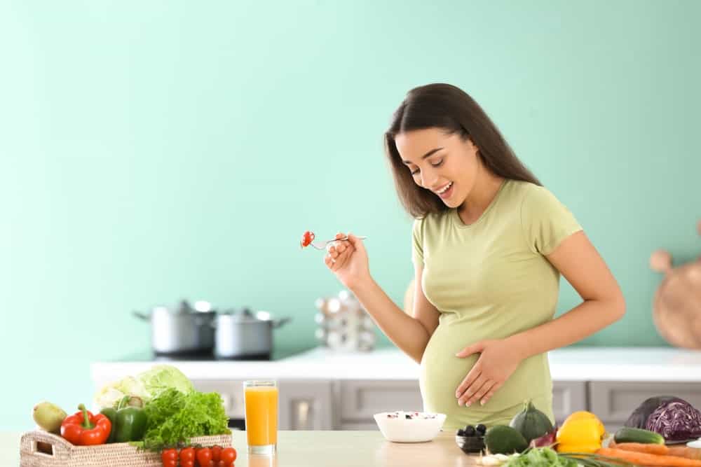 Pregnant woman enjoying healthy food after embryo transfer IVF.