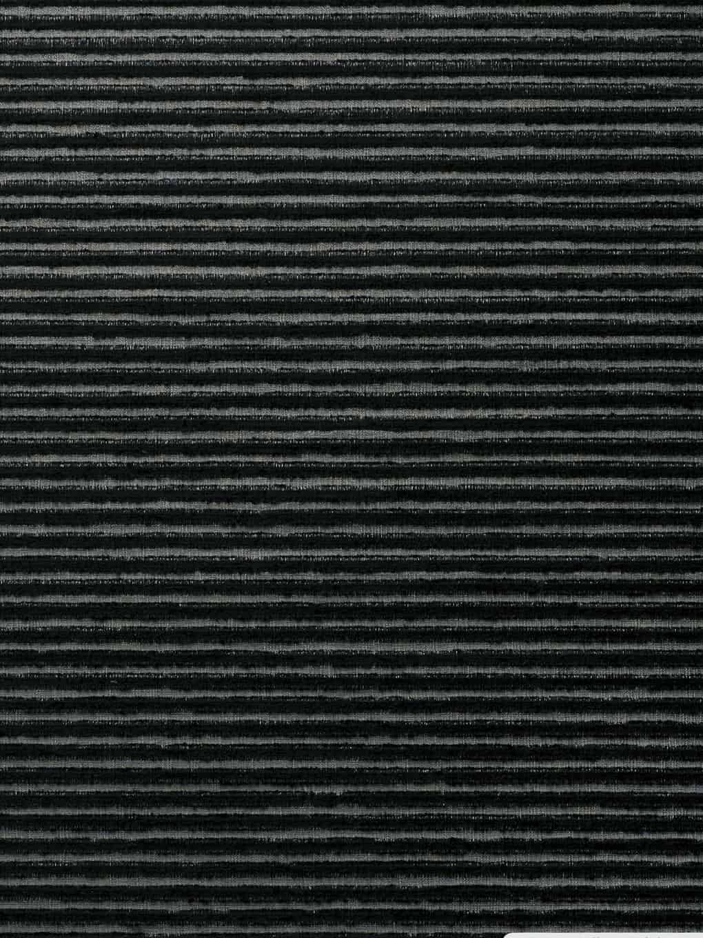 Close-up of black textured wall panel with horizontal grooves.