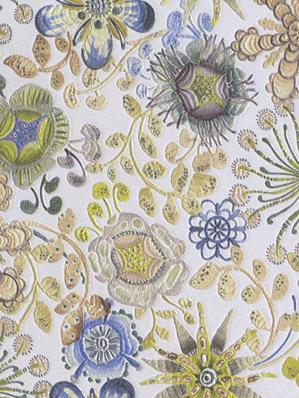 Embroidery of colorful, detailed floral patterns with various flowers and leaves on fabric.