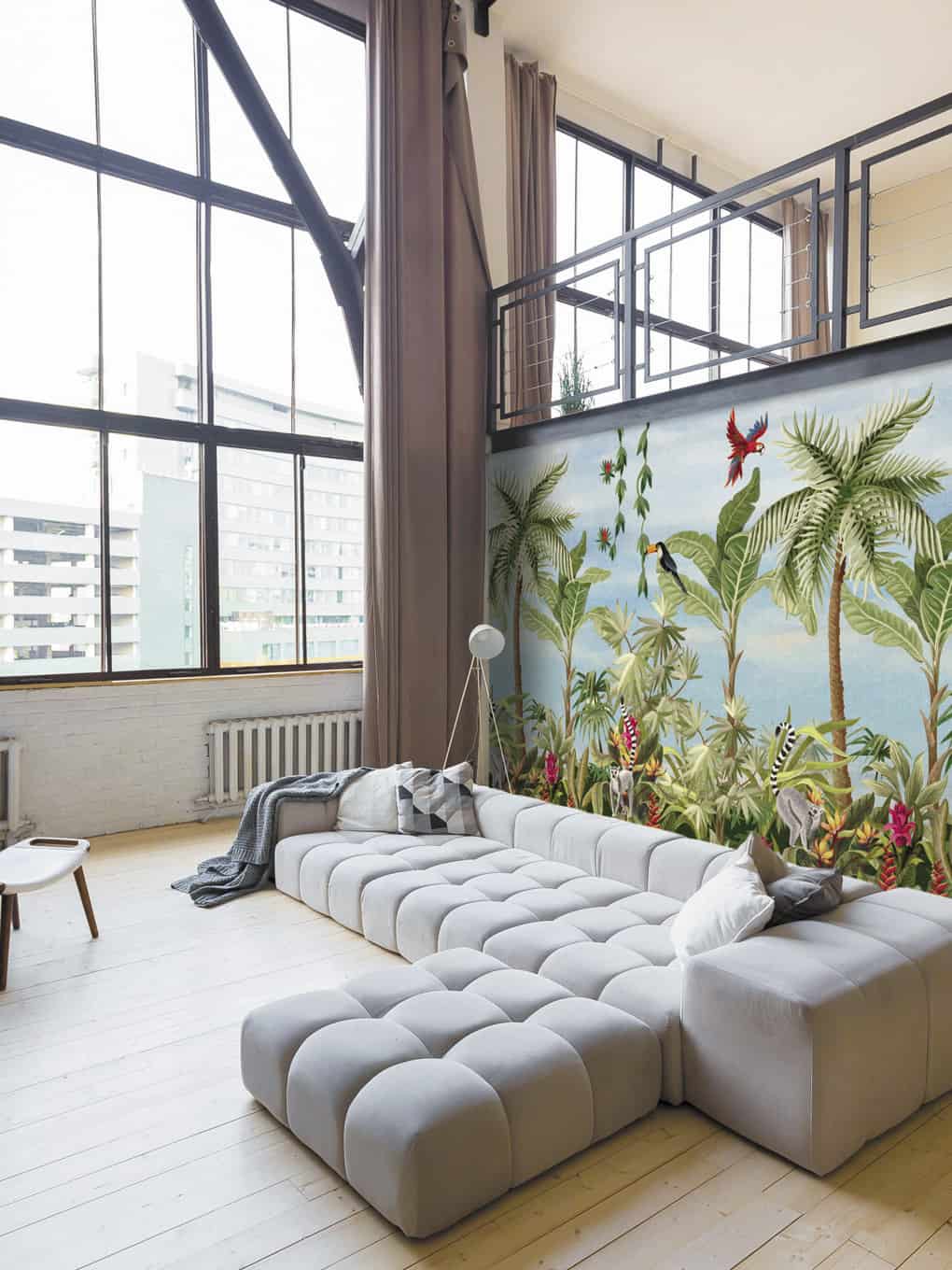 Modern living room with tropical mural, large windows, and contemporary furniture.