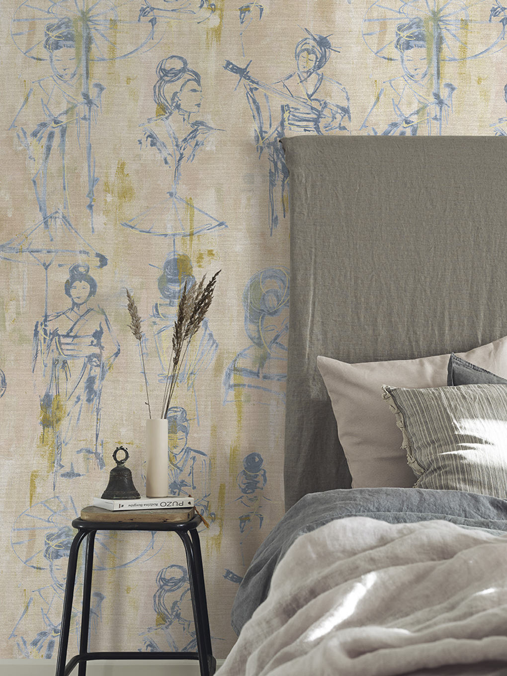Elegant bedroom with artistic wallpaper featuring sketched figures, complemented by a cozy bed and m.