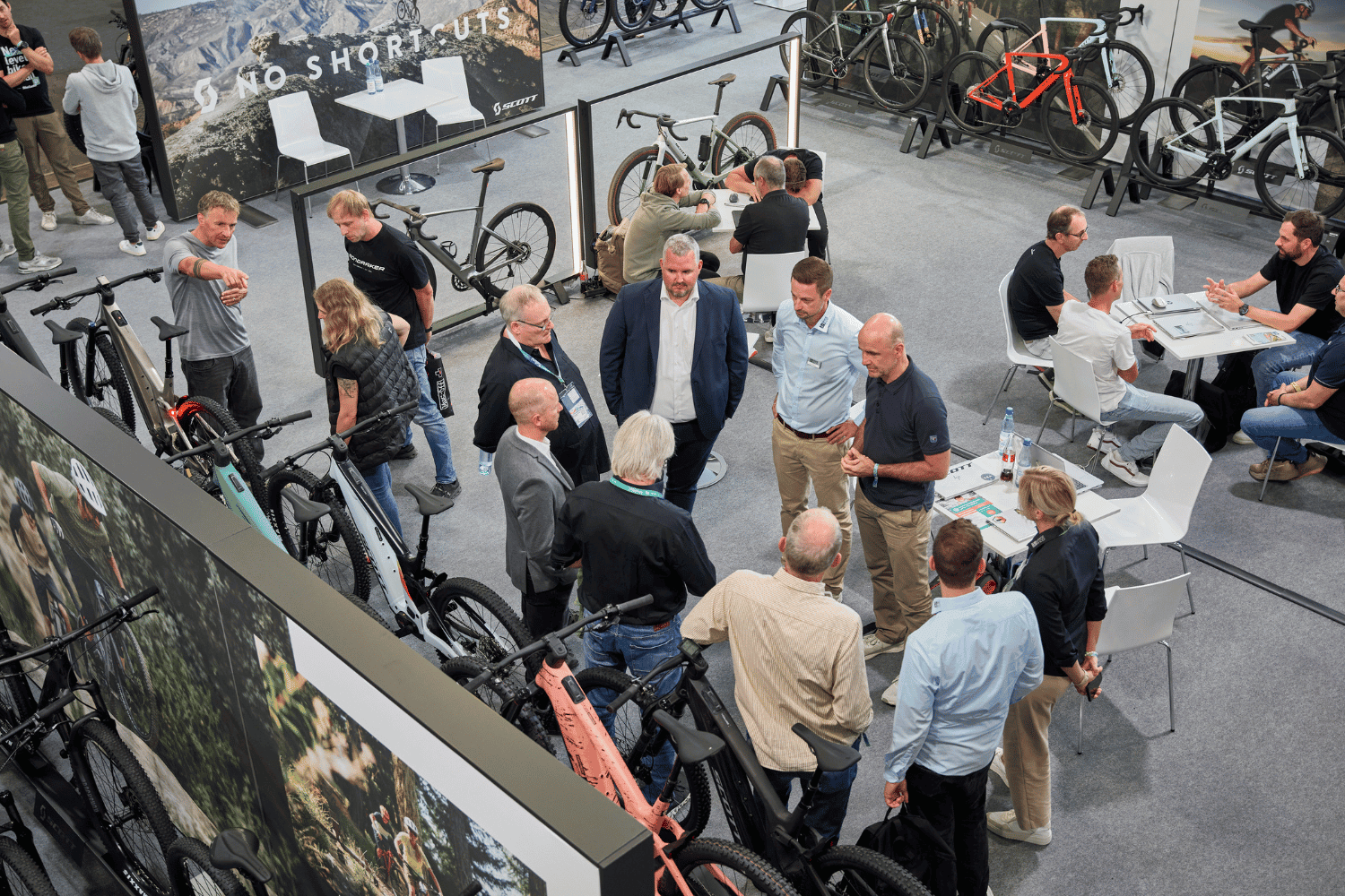 Menschen bei Fahrradmesse im modernen Showroom, Networking und Produktpräsentation.