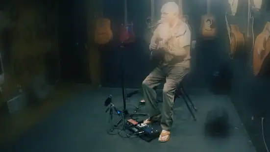 Guitar and vocal loop performance by a solo acoustic artist using live looping