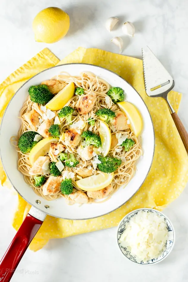 Lemon Broccoli Chicken Pasta in a skillet pan with a yellow dish cloth underneath