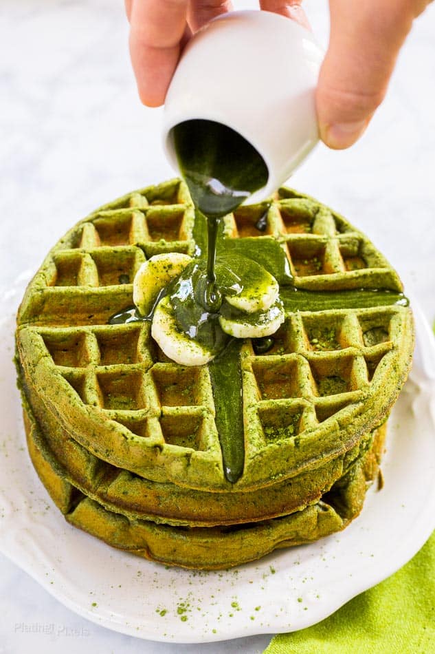 Matcha Green Tea Waffle on a white plate with matcha syrup