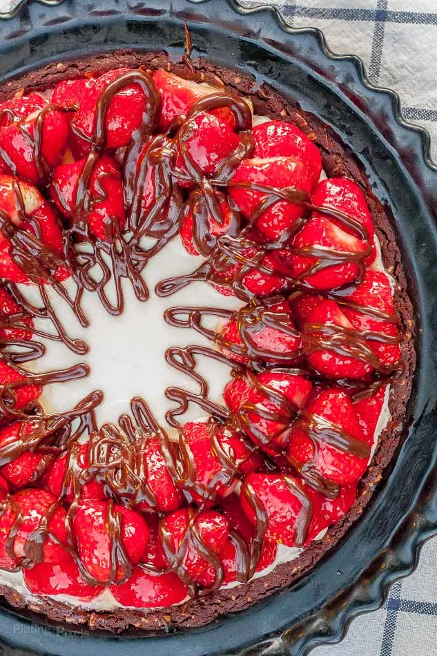 Close up of Strawberry Nutella No Bake Cheesecake drizzled with chocolate