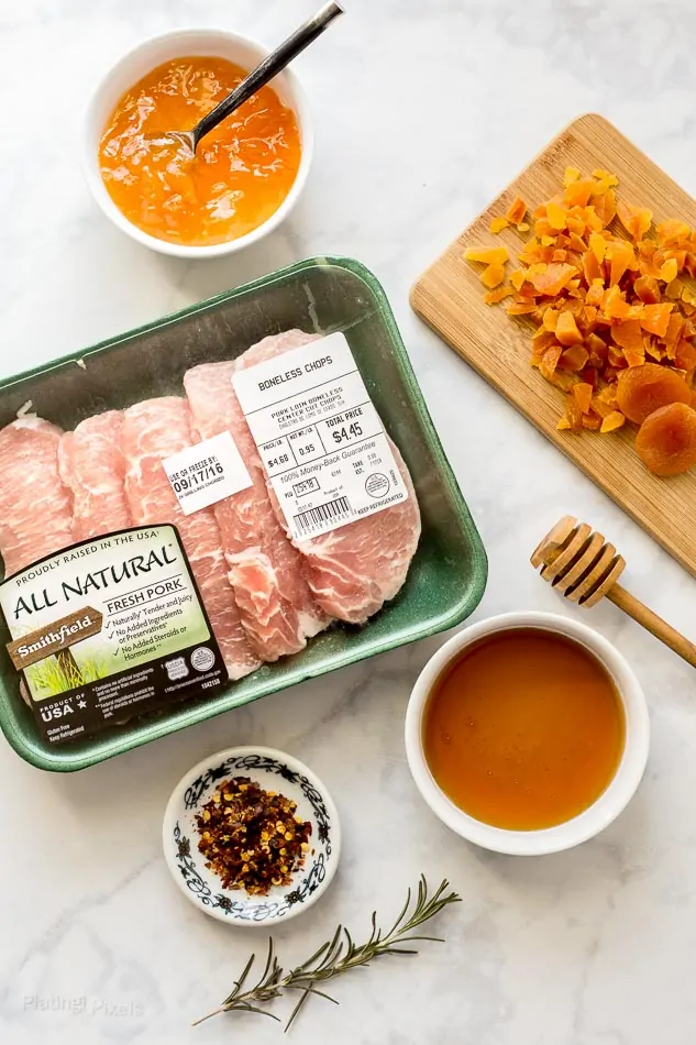 Overhead shot of ingredients for making Honey Apricot Pork Chops on a marble surface