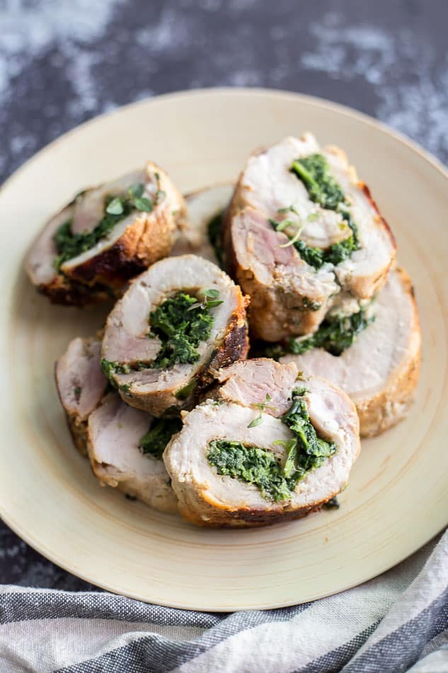 Slices of Spinach Parmesan Stuffed Pork Loin on a plate