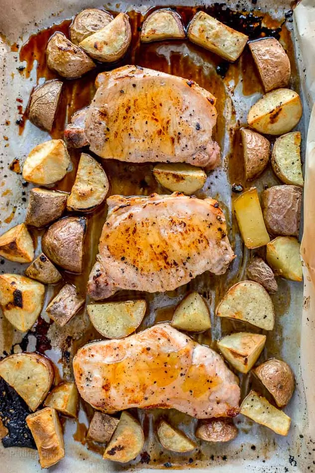Sheet Pan Honey Mustard Pork Chops with Potatoes on a baking sheet