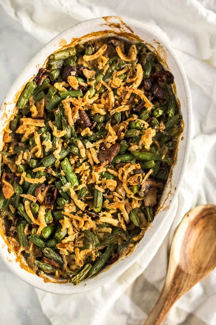 Overhead shot of cooked String Bean Casserole with Candied Bacon in a oval casserole dish