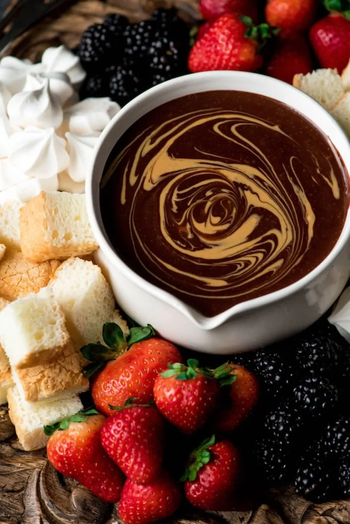 Dairy Free Chocolate Peanut Butter Fondue surrounded by mix-ins - Roundup of Romantic Chocolate Desserts for Valentine's Day