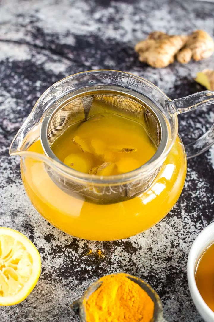 Brewing turmeric tea in a mesh-lined teapot 