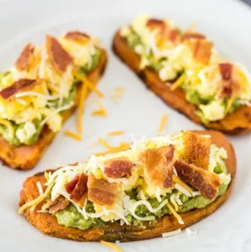 Three prepared Bacon and Egg Sweet Potato Bites on a plate