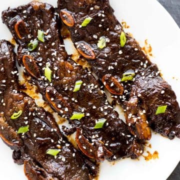 Three Kalbi Korean Short Ribs served on a white plate