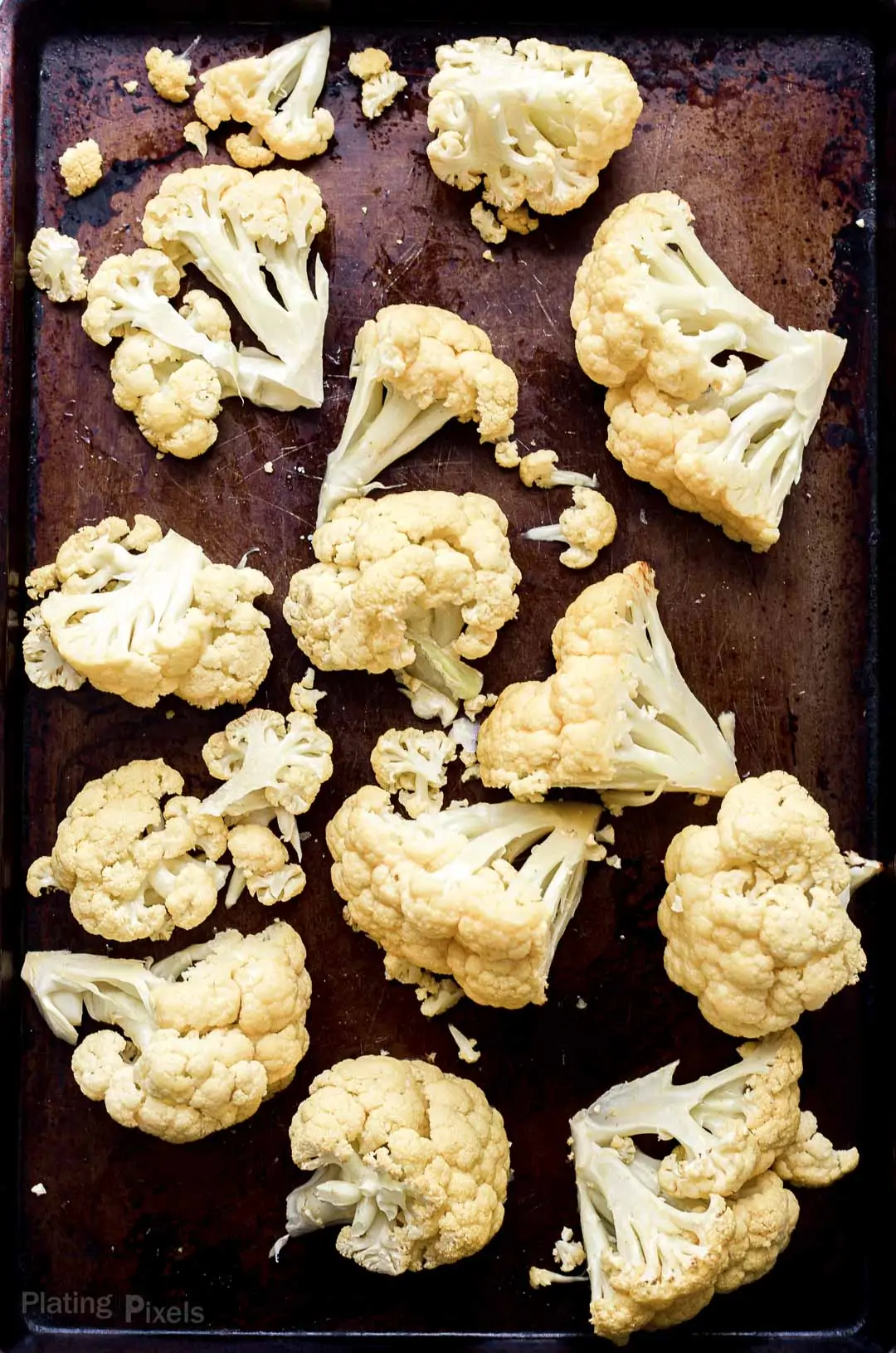 Roasted cauliflower florets on a baking sheet