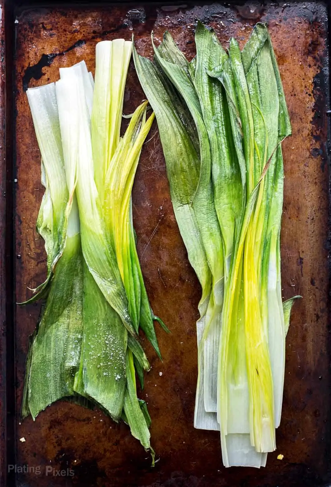 Roasted leeks on a baking sheet