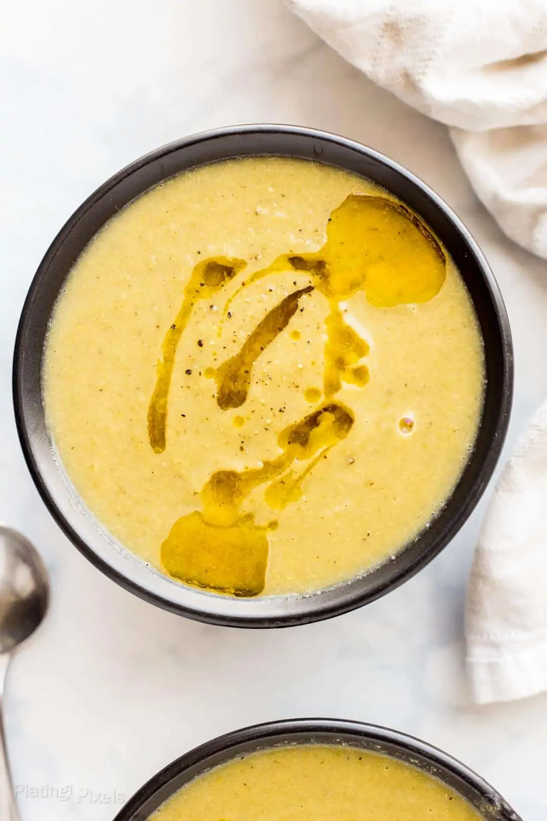 Bowl of Leek and Cauliflower Soup drizzled with olive oil