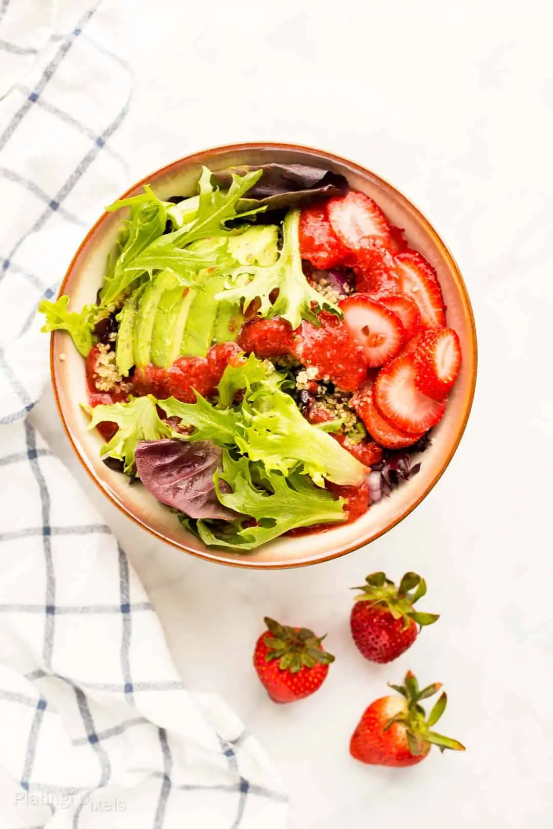 Prepared Summer Strawberry Salad next to fresh stawberries