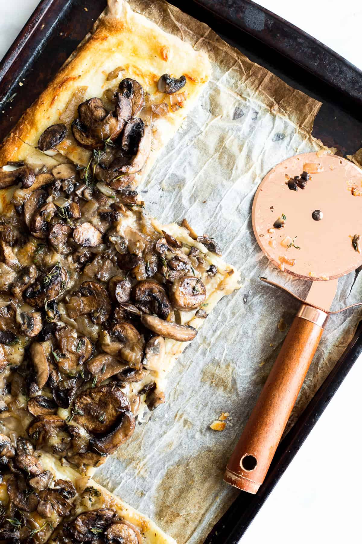 Mushroom Tart on a baking sheet with squares cut out of it