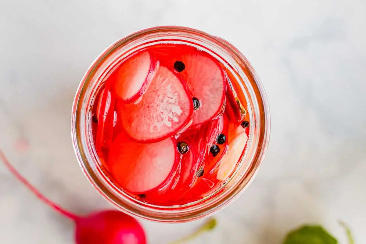 Horizontal image of Refrigerated Pickled Radishes in a jar