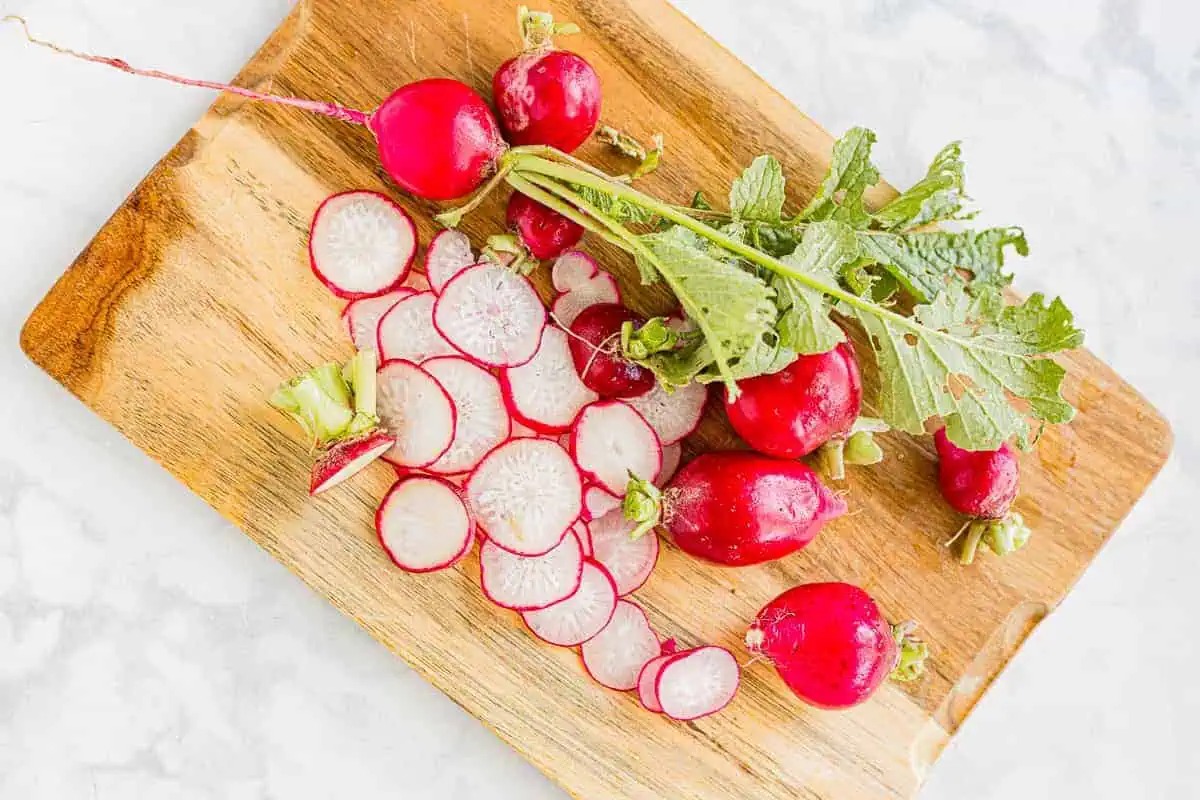 Sliced radishes on a cutting board