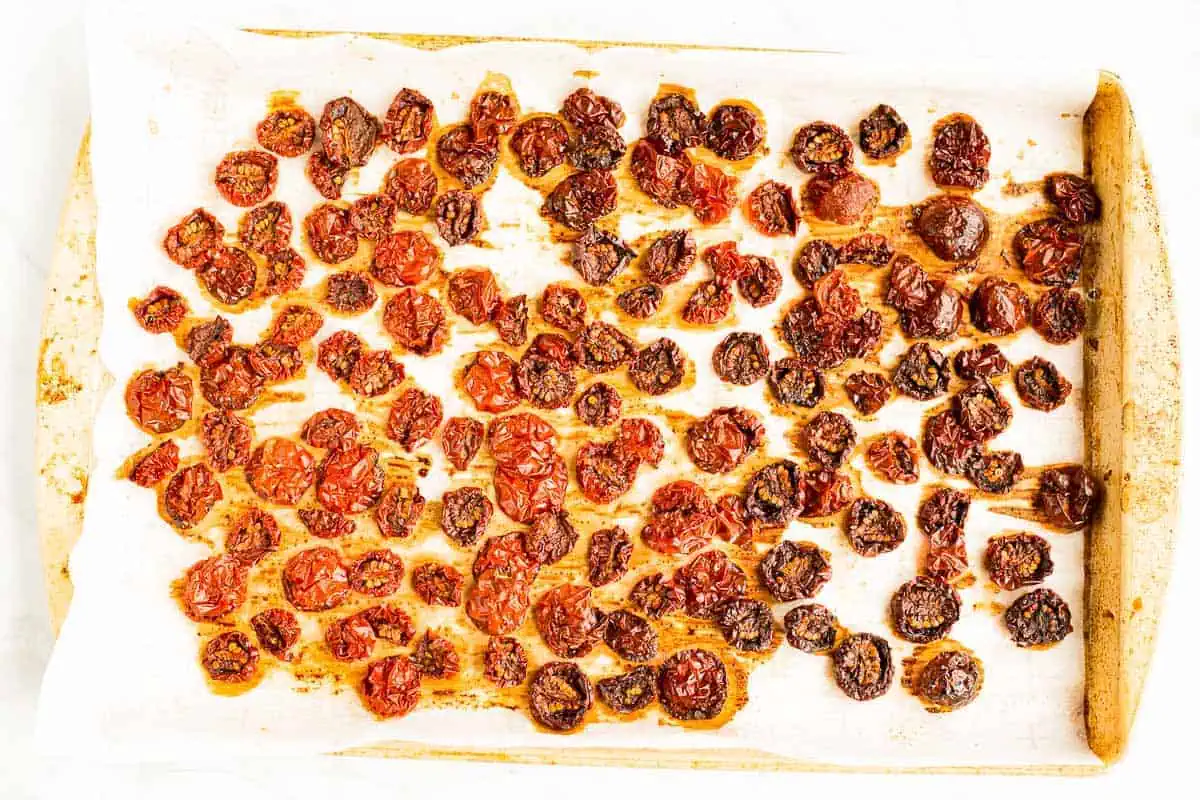 Oven Dried Tomatoes on a baking sheet horizontal image