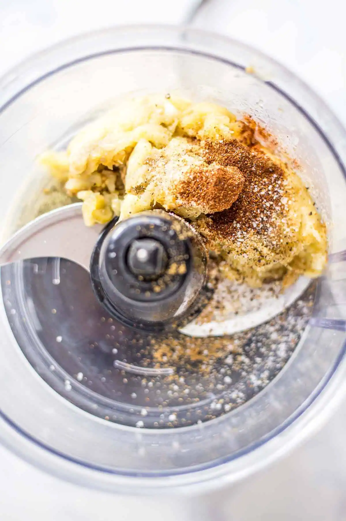 Adding ingredients into food processor to make eggplant dip