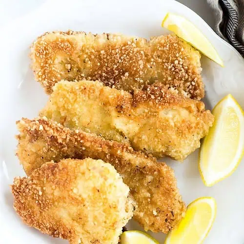 Pork Schnitzel on a plate garnished with lemons