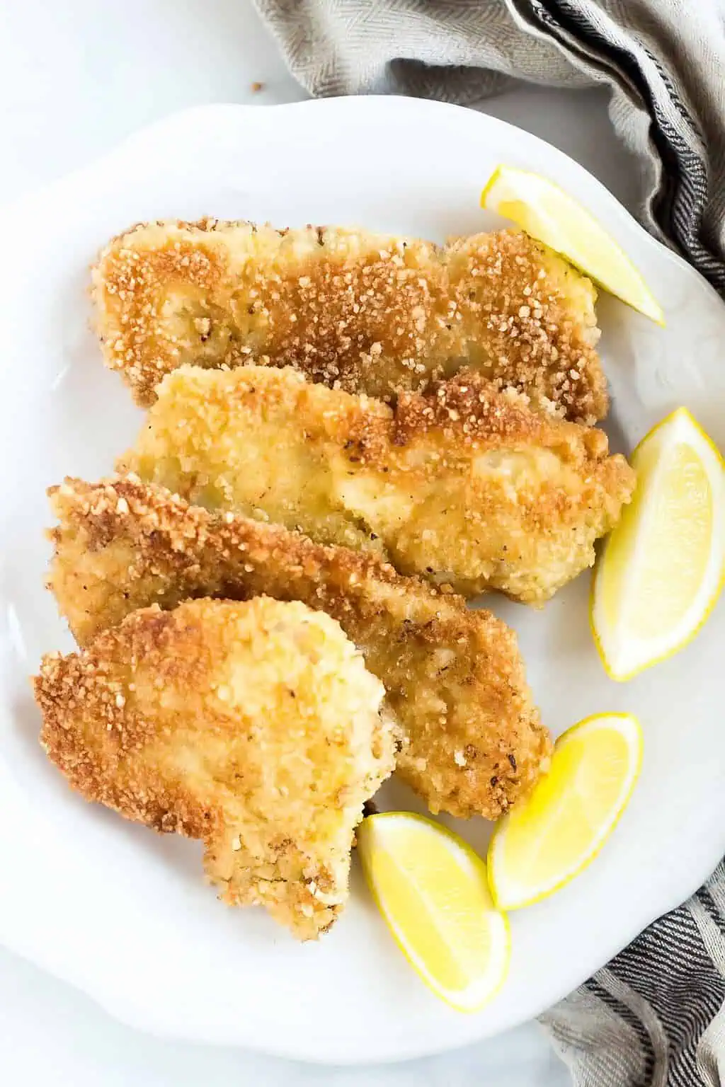 Pork Schnitzel on a plate garnished with lemons