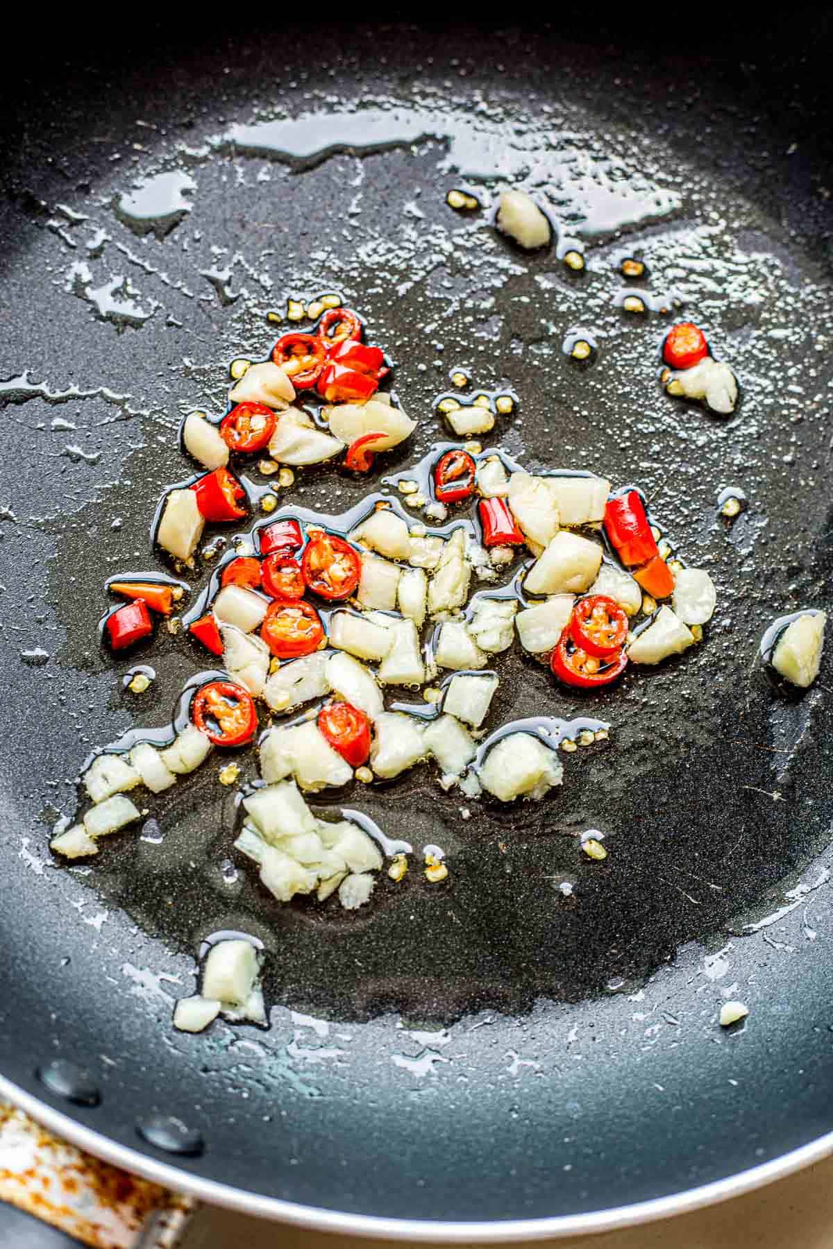 Garlic and Bird's Eye chilies cooking in oil