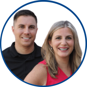 A man in a black shirt and a woman in a sleeveless red top are smiling, posing together against a white background, capturing the friendly spirit of our About Us page.