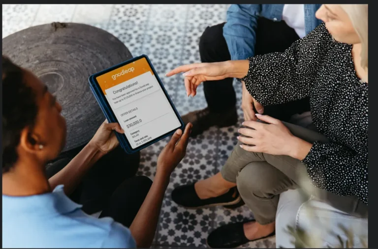 Three people sit together as one person holds a tablet displaying a "Congratulations" message, a scholarship award notification from Gradscape, and information about flexible finance options for recipients.