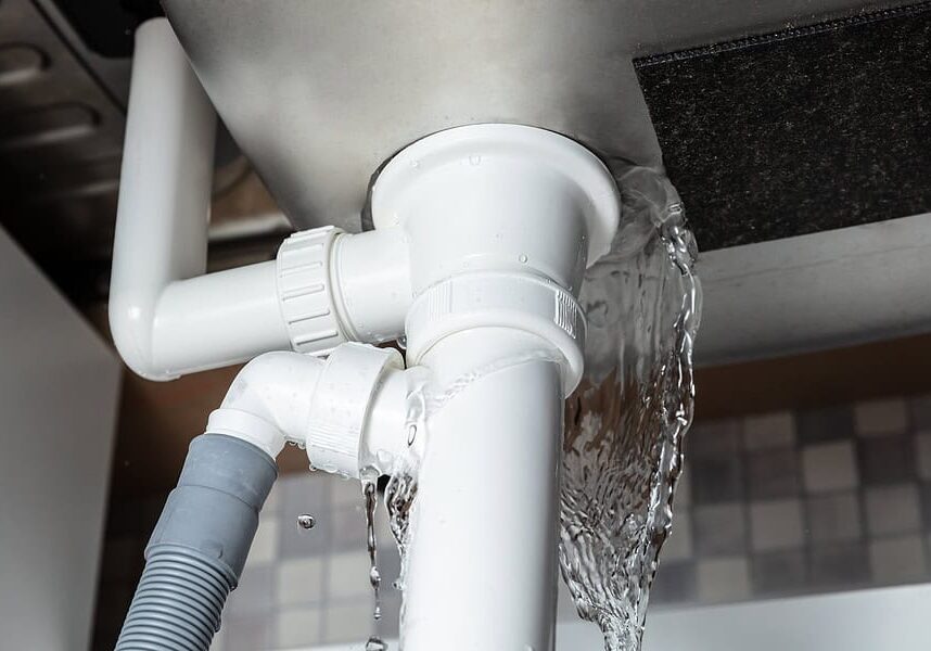 Close-up Of Water Is Leaking From The White Sink Pipe