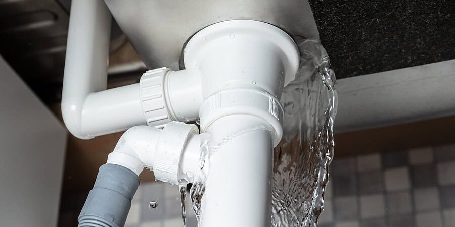 Close-up Of Water Is Leaking From The White Sink Pipe