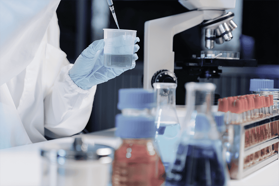Technician using a digital caliper to measure a metal component for quality control.