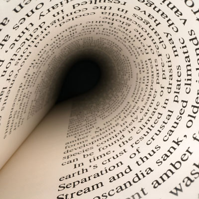 A spiral view of a book page with printed text forming a tunnel effect.